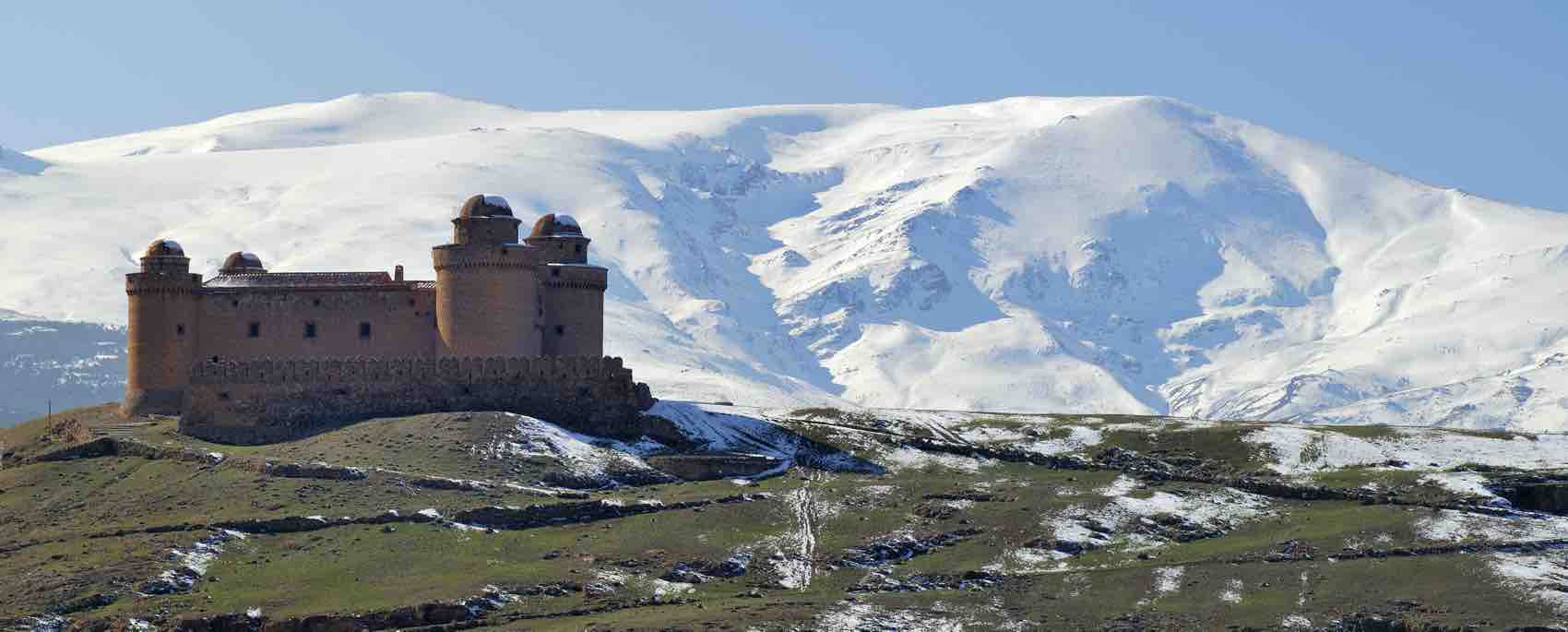 The imposing fortress of Calahorra, near the snowy mountain of Sierra Nevada