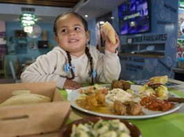 Young girl Salome eating tapas in Arroyo de la Miel
