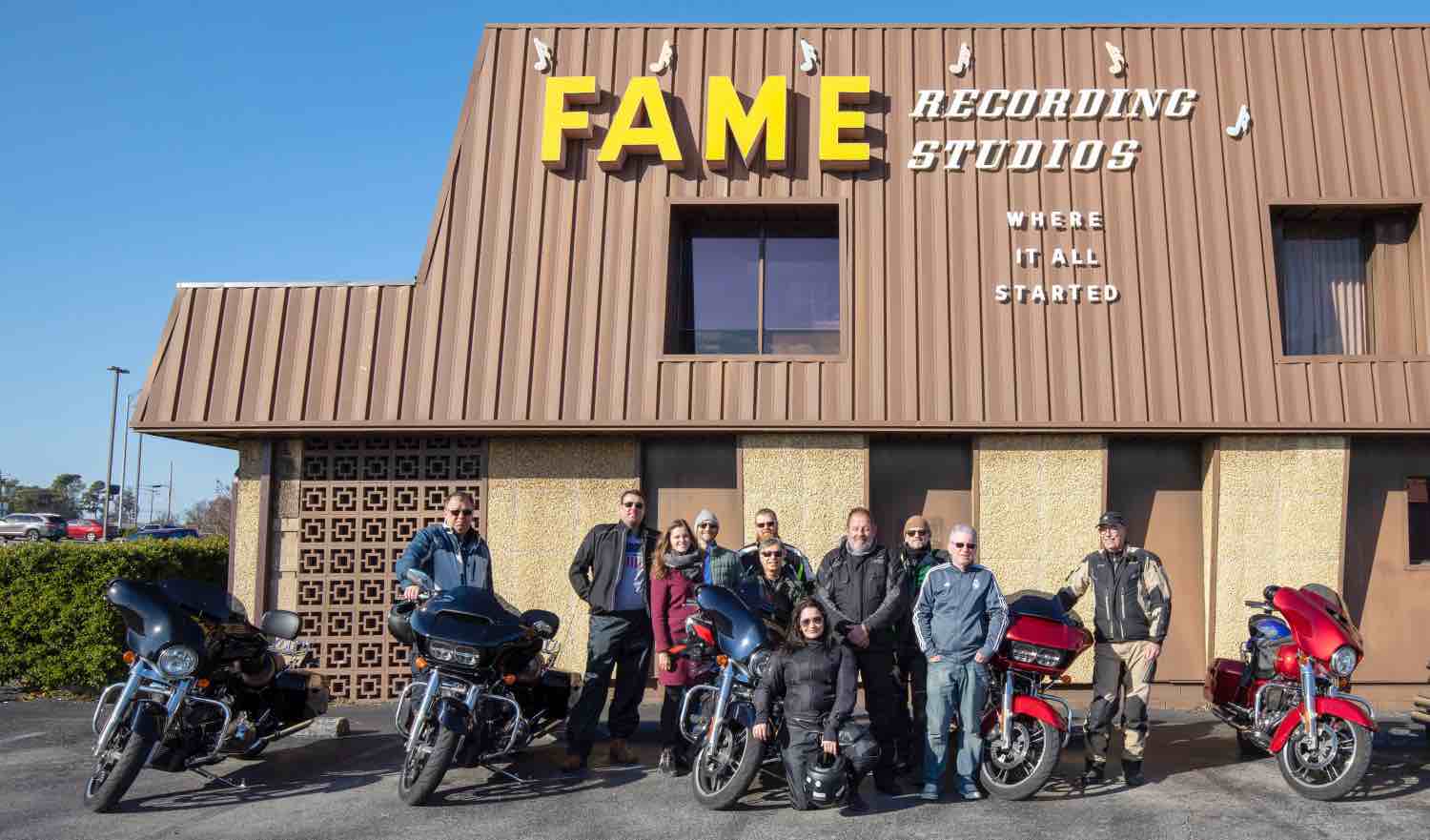 A group stops for a photo before taking a tour of FAME Recording Studios.
