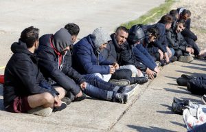 All Men: Migrant men wait to be processed by police and border force officials.