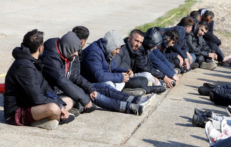 All Men: Migrant men wait to be processed by police and border force officials.