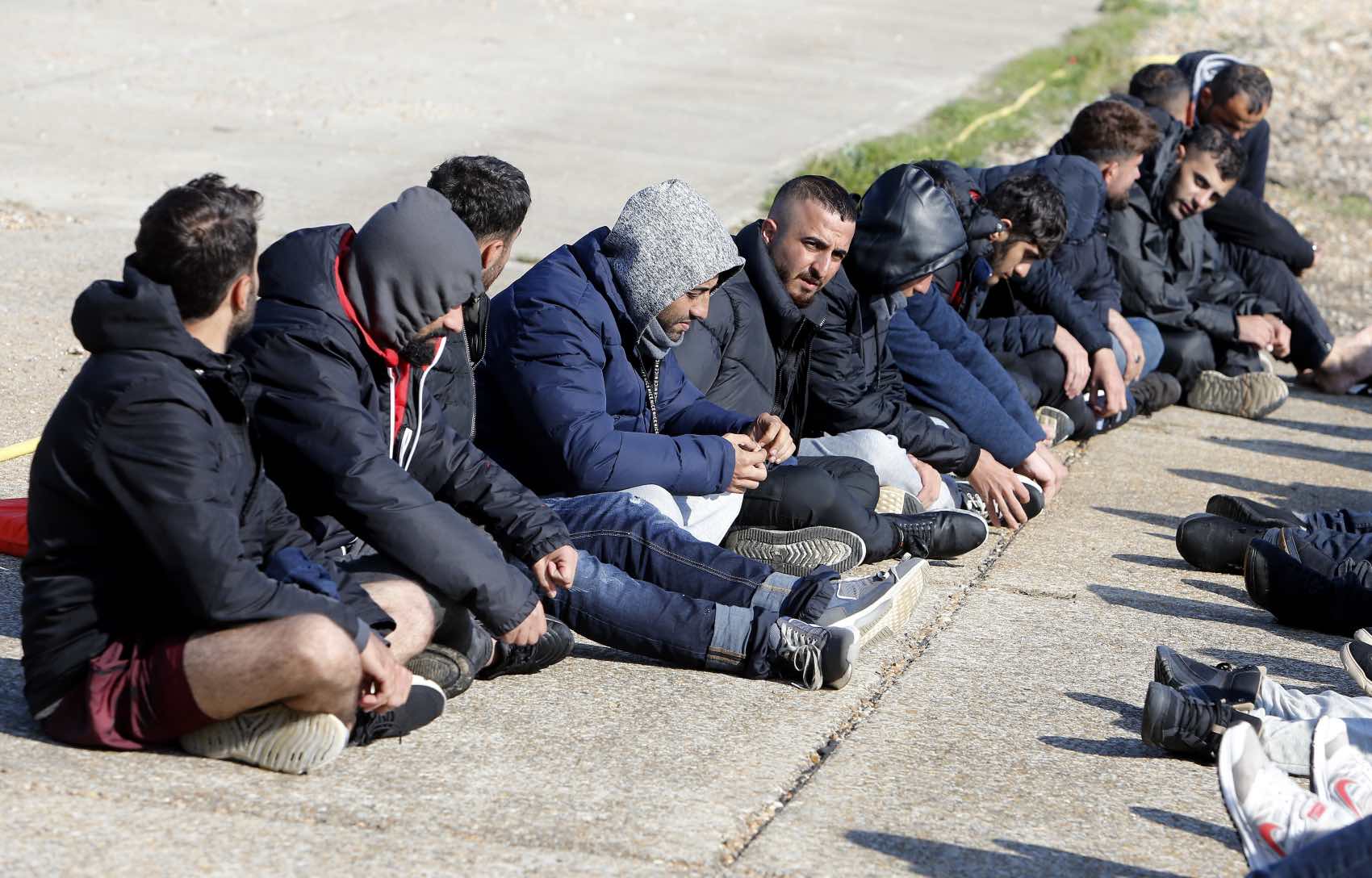 All Men: Migrant men wait to be processed by police and border force officials.